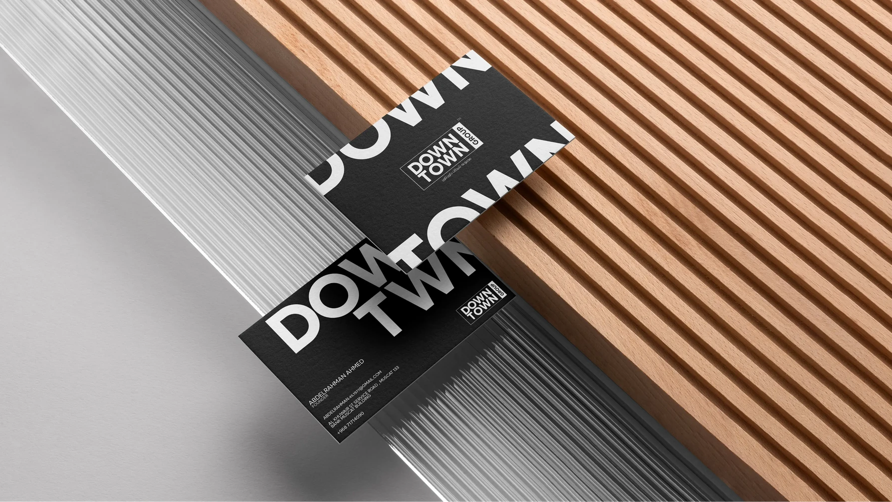 Downtown Group business cards on a wooden slat surface